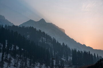 Beautiful mountain sunset view from Kashmir, winter season snow covered mountain with pine trees