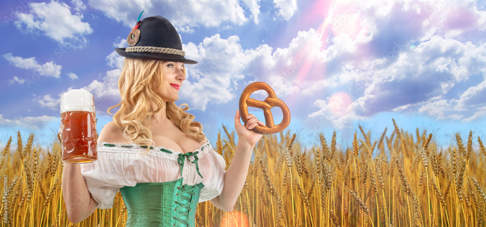 Wall mural Oktoberfest girl waitress holding pretzel. Woman in dirndl, tyrolean hat serving beer mug. Wheat field in background. Traditional Bavarian, German, Austrian party, autumn festival.