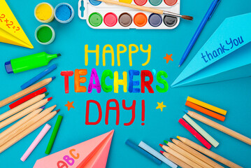 Childish lettering for Teachers' Day. Appreciation of teachers top view flat lay concept. Colored paper, multi-coloured letters, supplies