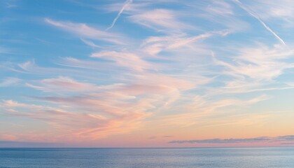 Obraz premium Sailing into Twilight: Pink Cirrus Clouds Above a Blue Canvas