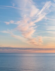 Obraz premium Sunset Mirage: Blushes of Cirrus Clouds Adorn Azure Waters