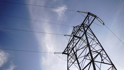 low angle of high tension electric tower against the sky