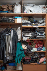 Messy closet. Clutter in the wardrobe with clothes