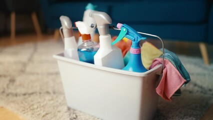 Cleaner places bucket with detergents on floor, performing cleaning service 