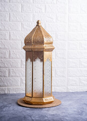 Eid Mubarak and Ramadan Kareem concept background, Golden lantern lamp on the table with copy space for greeting text