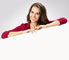 Portrait of happy smile young brunette woman wear red casual cloth, show peep from blank signboard...