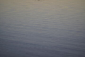 Calm surface of real water on a river. Serene ripples of pure river water, perfect for a water background.