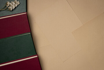 Sheets of paper background with books. Vintage. Flat lay, top view. Copy space