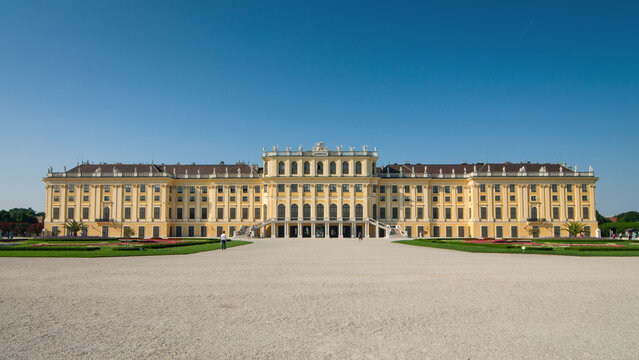 anorama of Sch&ouml;nbrunn Palace - main facade. View from Palace Park at a huge yellow baroque-styled 18th century palace. Vienna, Austria - June 17, 2013.