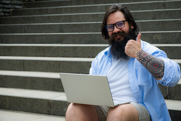 a man with a beard shows class to his work