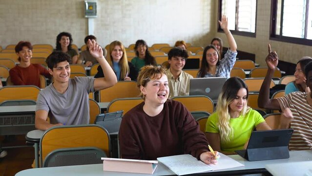 Multiracial students raising hands during math lesson inside university school class room - Diverse young people, classmates and education concept 