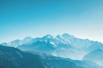 Fototapeta premium A clear view of a majestic mountain range in the distance under a blue sky, A majestic mountain range under a clear blue sky