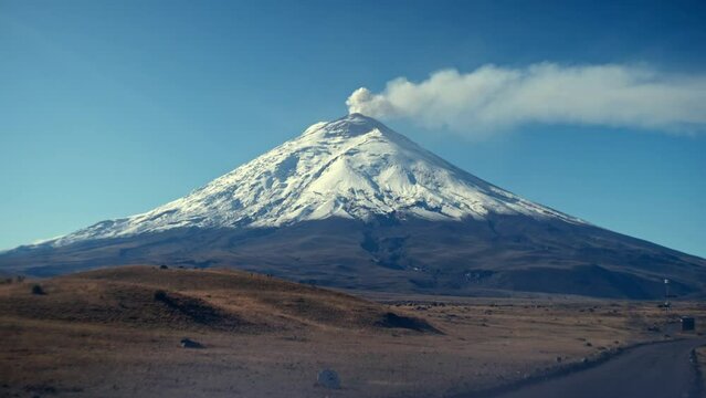 Experience the raw power and breathtaking beauty of Cotopaxi Volcano as it emits plumes of smoke from its towering summit. This stunning footage captures the dynamic nature of one of the world's highe