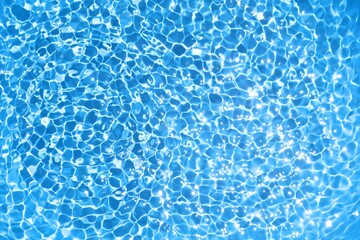 Blue water ripple background in swimming pool