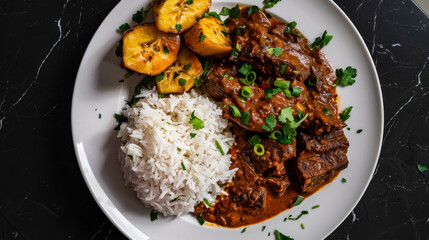 Aromatic ghanaian beef stew served with white rice and fried plantains, garnished with fresh herbs on a white plate