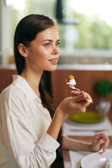 Happy Couple Enjoying Romantic Dinner at Home Woman Smiling in Ecstasy While Indulging in Delicious...