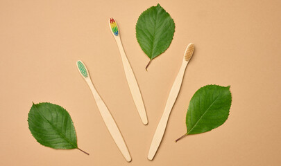 Wooden toothbrush on a brown background, plastic rejection concept, zero waste
