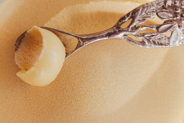 Vanilla ice cream with silver spoon. Ice cream texture. Frozen creamy dessert. Gelato isolated....