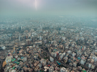 aerial view of high, congested buildings of Dhaka city with no trees and greenery visible. Thunder...