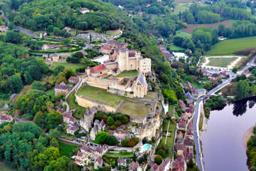 View of Chateau de Beynac in Beynac et Cazenac at sunrise as viewed from a hot air balloon...