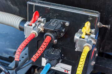 Connections of the air, electricity and ABS intakes of a semi-trailer, red direct air intake...