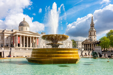 Fountain on Trafalgar square with National Gallery at background, London, UK