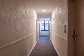 Interior of a carpeted hotel corridor doorway