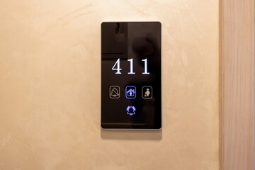 Electronic hotel room number mounted on a wall
