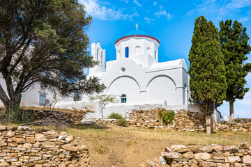 Traditional style white church Panagia Poulati with blue dome on sea coast near Kastro village,...