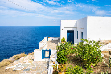Typical white house with blue gate against blue sea in Kastro village, Sifnos island, Greece