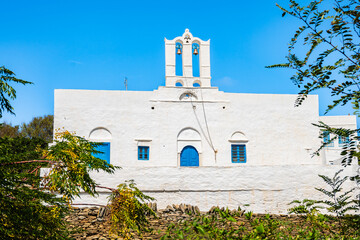 Typical Greek white church in Artemonas village against blue sunny sky, Sifnos island, Greece