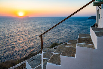 Steps to typical Greek house on sea coast at sunrise in Kastro village, Sifnos island, Greece