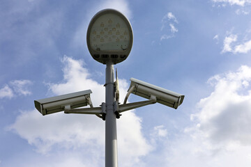 Outdoor surveillance video cameras and led light in sky. Cctv camera, concept for security, privacy...