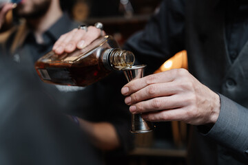 Bartender pours whiskey for tasting.