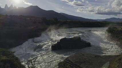 Sunset Silhouettes of Torres del Paine Over Waterfall Cascade