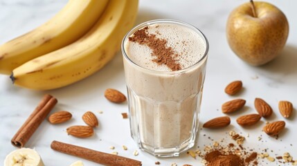 Protein shake ingredients on white table glass of protein drink bananas protein powder almonds and cinnamon sticks