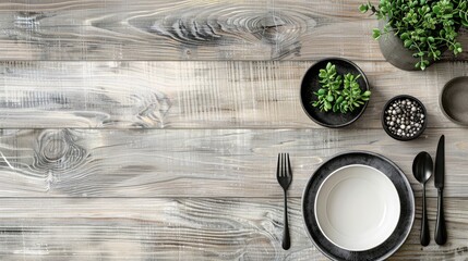 a dining table setting from above, featuring a pristine white plate, sleek cutlery, and a black place mat on a warm wooden surface, offering ample copy space for text or design.