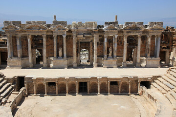 Fototapeta premium Antique columns and statues in ancient amphitheater of Hierapolis, Pamukkale, Denizli City, Turkey.