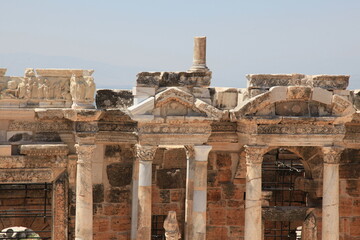 Antique columns and statues in ancient amphitheater of Hierapolis, Pamukkale, Denizli City, Turkey.