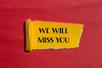 We will miss you words written on torn yellow paper with red background. Conceptual we will miss...
