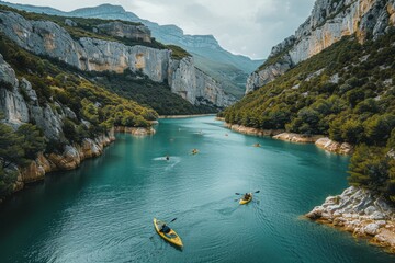 Two Kayakers Paddling in River Surrounded by Mountains