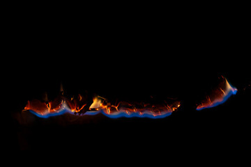 burning paper, glowing edge of paper on a black background.