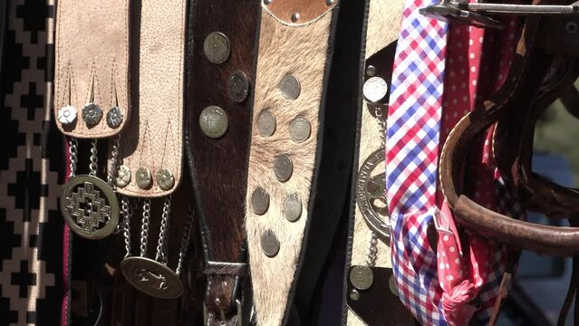 Handmade Argentine gaucho belts. Leather belts with coin decorations and carved metal art. Pampa guard style woven belt. Traditional accessories of the Argentine gaucho's clothing. Traditional craft 