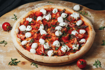 Freshly Baked Margherita Pizza With Cherry Tomatoes and Mozzarella on a Wooden Board