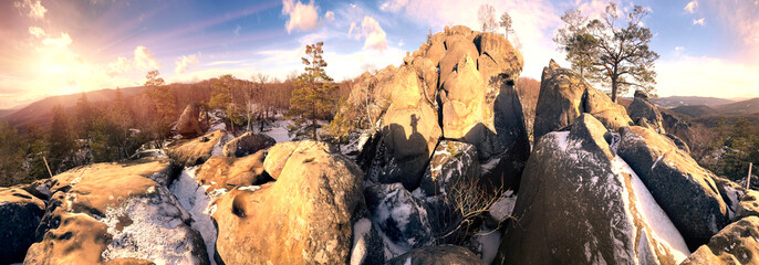 Dovbush rocks in winter in Bubnyshche, Carpathians, Ukraine, Europe. Huge stone giants rise in the snowy transparent beech forest, all-round panoramic views are unique without leaves