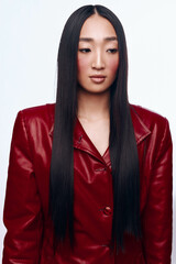 Stylish Asian Woman with Long Black Hair Wearing Red Leather Jacket Posing for Camera