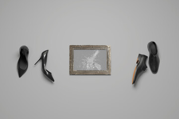 Vintage picture frame with broken glass plate next to female and male shoes. 3D Rendering