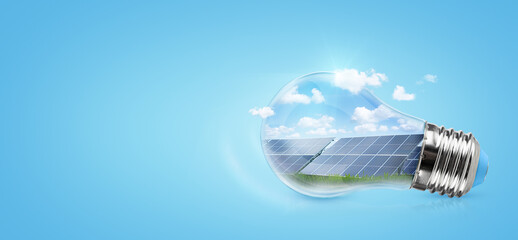 Solar panels in a light bulb on blue background. Green saving energy concept.