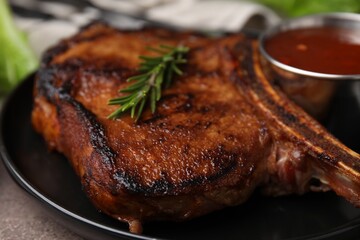 Tasty grilled meat, rosemary and marinade on table, closeup