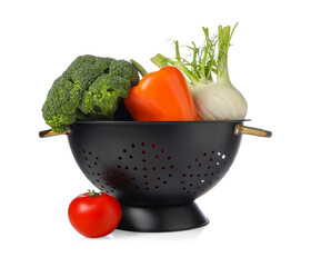 Colander with fresh vegetables isolated on white